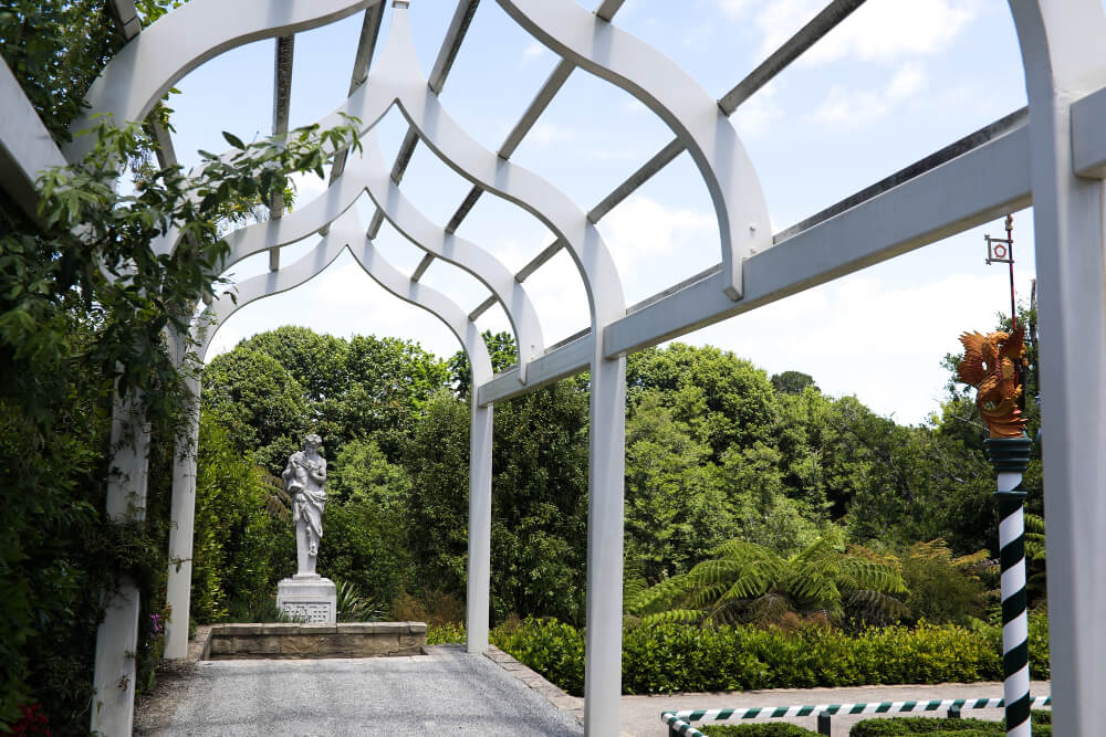 low angle shot white wooden garden arch