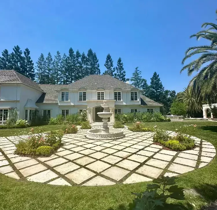 estate landscape with fountain and flower beds