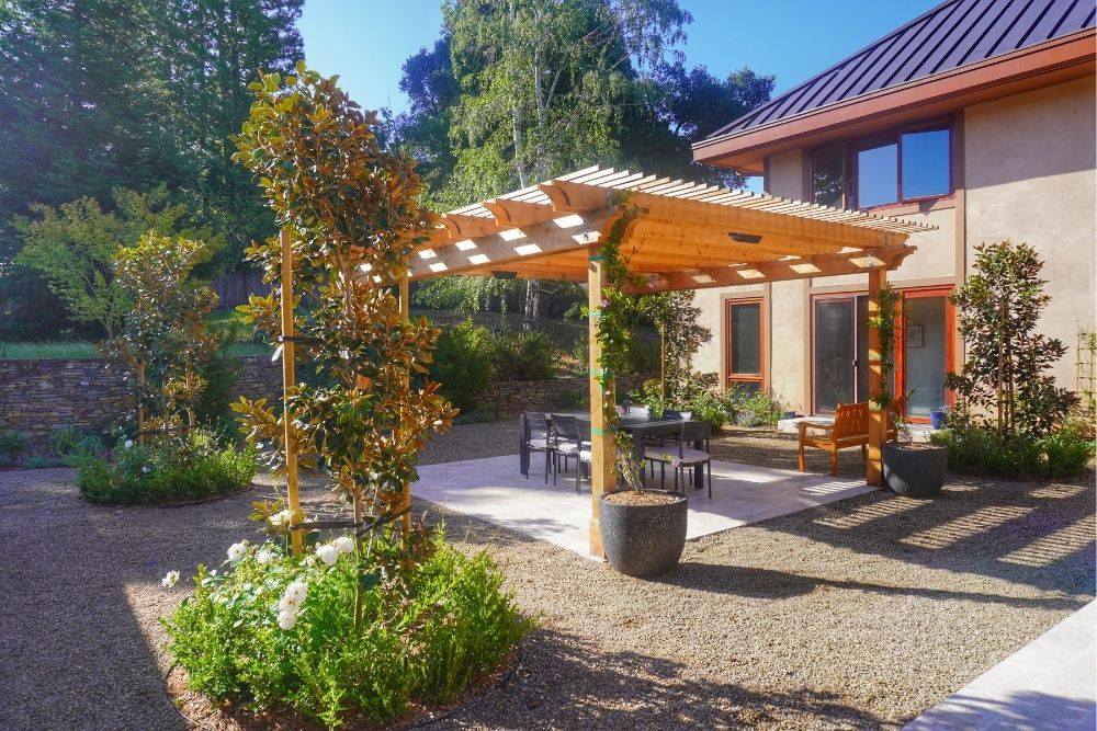 Patio with wooden pergola and garden