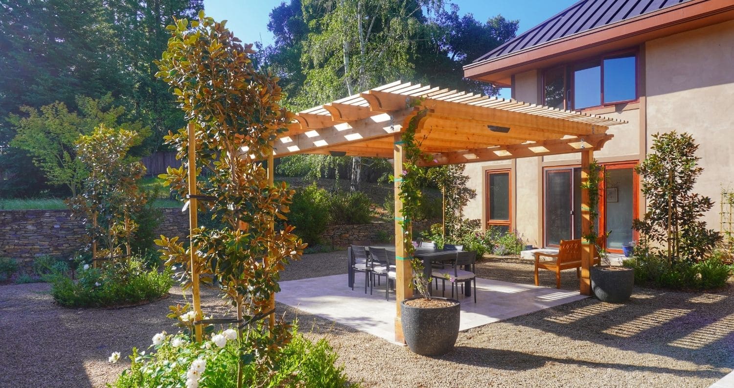Patio with wooden pergola and garden